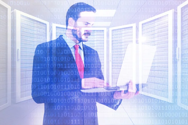 Composite image of focused businessman using his laptop — Stock Photo, Image