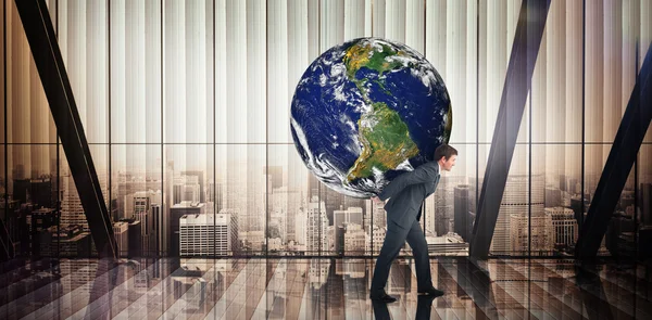 Composite image of businessman carrying the world — 图库照片