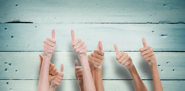 Composite image of thumbs raised and hands up — Stock Photo, Image