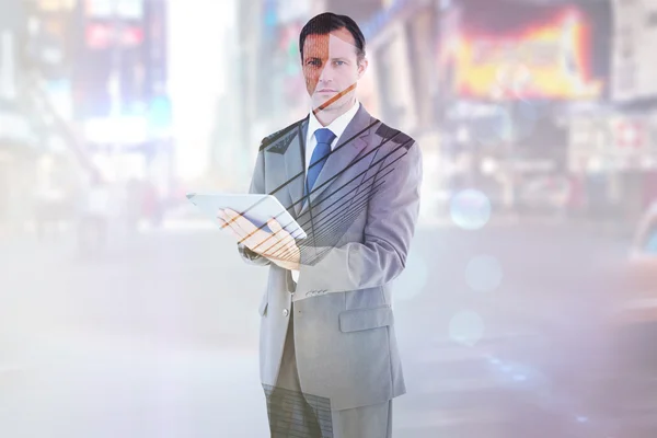 Serious charismatic businessman holding a tab — Stock Photo, Image