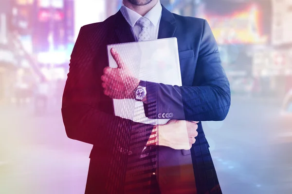 Composite image of mid section of businessman holding computer — Stock Photo, Image