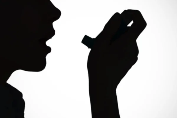 Menutup seorang wanita menggunakan inhaler asma. — Stok Foto