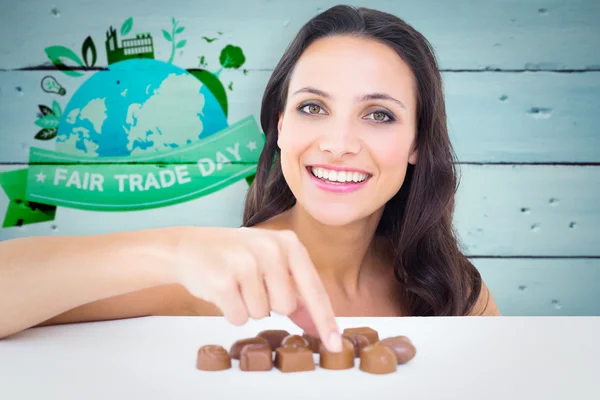 Pretty brunette picking out chocolate — Stock Photo, Image