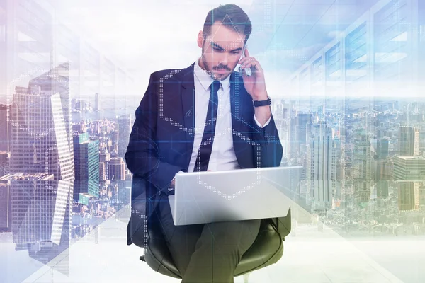 Businessman using laptop while phoning — Stock Photo, Image