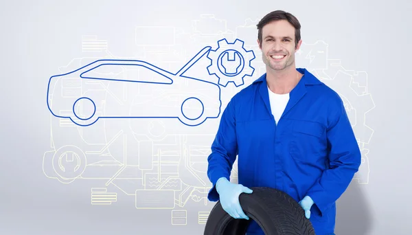 Mechanic holding tire — Stock Photo, Image