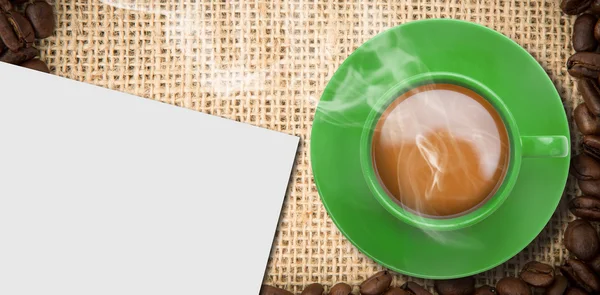 Composite image of green cup of coffee — Stock Photo, Image