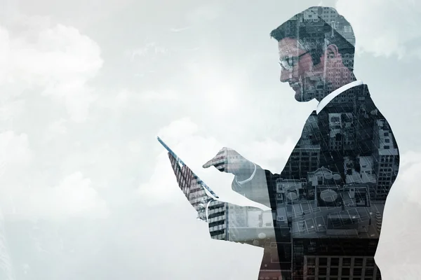 Composite image of mid section of a businessman touching tablet — Stock Photo, Image