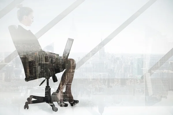 Businesswoman sitting on swivel chair with laptop — Stock Photo, Image