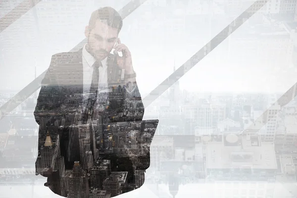 Businessman using laptop while phoning — Stock Photo, Image