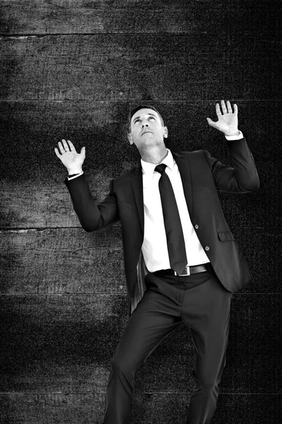 Composite image of businessman with hands up — Stock Photo, Image