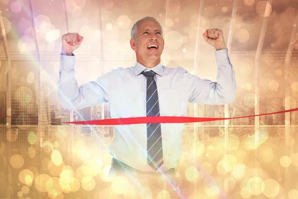 Composite image of businessman winning race — Stock Photo, Image