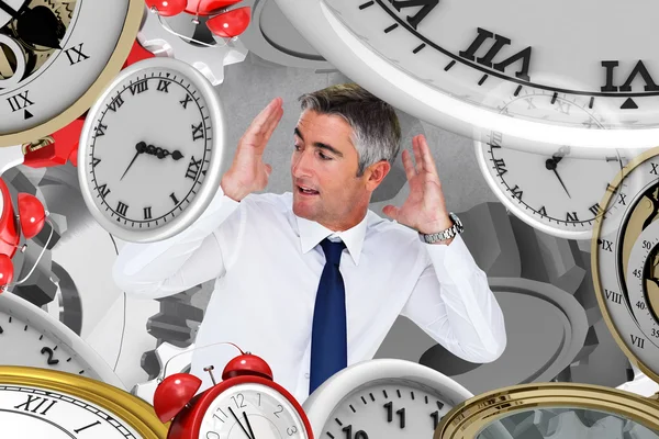 Composite image of businessman looking up with arms up — Stock Photo, Image