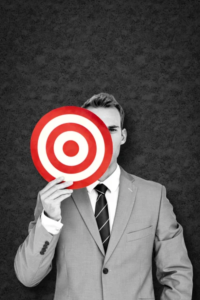 Composite image of businessman holding target — Stock Photo, Image