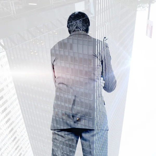 Composite image of thinking businessman holding glasses — Stock Photo, Image