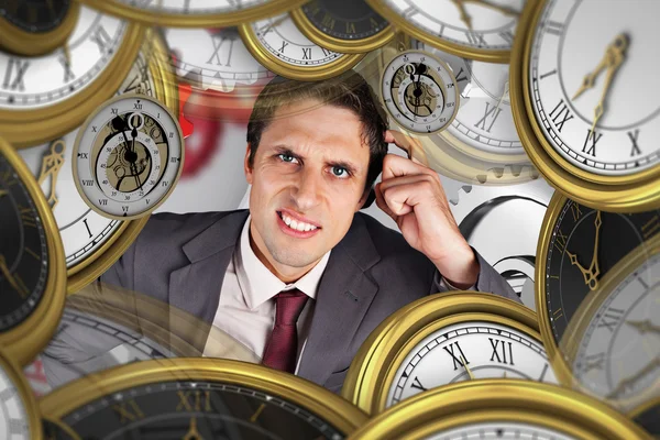 Composite image of thinking businessman scratching head — Stock Photo, Image