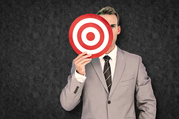 Composite image of businessman holding target — Stock Photo, Image