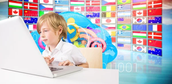 Composite image of cute boy using laptop — Stock Photo, Image