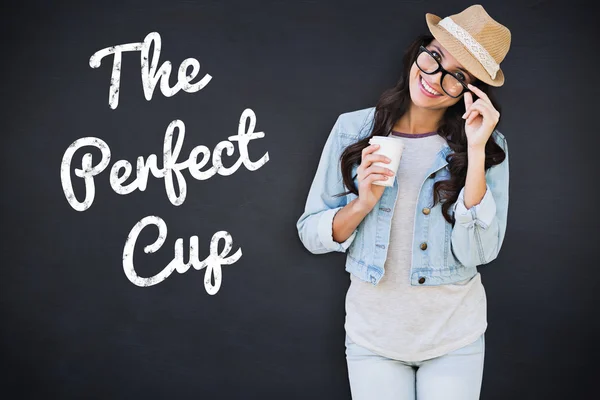 Composite image of brunette with disposable cup — Stock Photo, Image