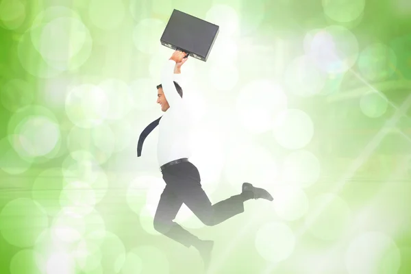 Smiling businessman leaping while briefcase — Stock Photo, Image