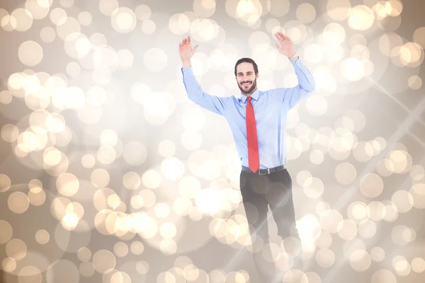 Smiling businessman stepping with hands raised — Stock Photo, Image