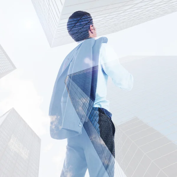 Composite image of businessman holding his jacket — Stock Photo, Image