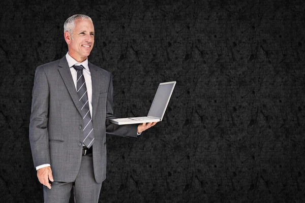 Composite image of businessman using laptop — Stock Photo, Image