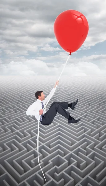 Hombre de negocios volando con globo — Foto de Stock