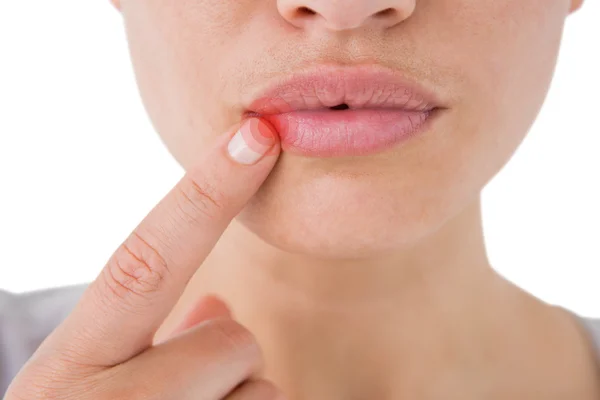 Mujer señalando sus labios — Foto de Stock