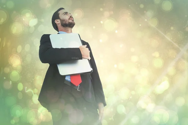 Concentrating businessman in suit holding laptop — Stock Photo, Image