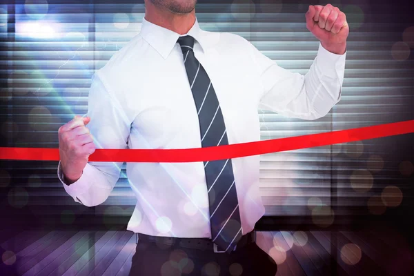 Businessman crossing the finish line — Stock Photo, Image