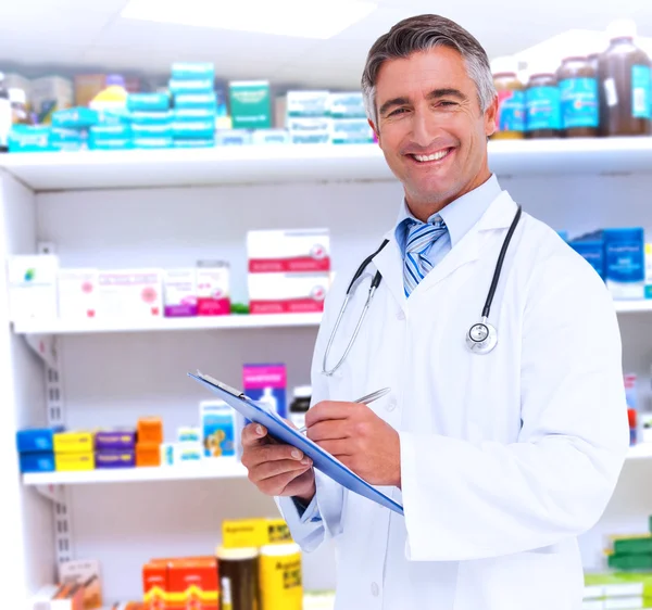 Happy doctor writing on clipboard — Stock Photo, Image