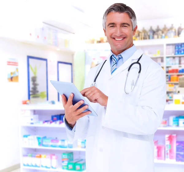 Happy doctor using tablet pc — Stock Photo, Image