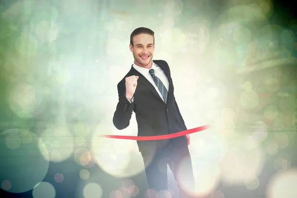 Businessman crossing the finish line — Stock Photo, Image