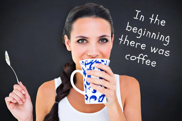 Composite image of pretty brunette having cup of tea — Stock Photo, Image