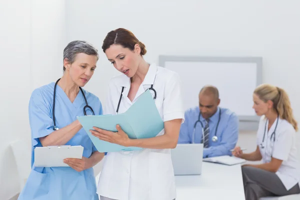 Team of doctors working on their files — Stock Photo, Image