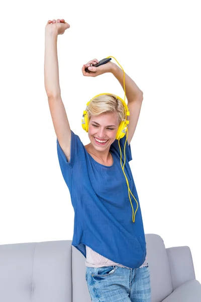 Blonde woman listening music with phone — Stock Photo, Image