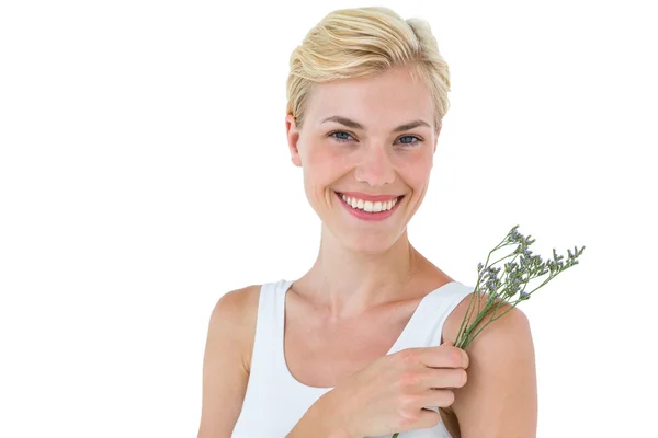 Blonde woman smelling flowers — Stock Photo, Image