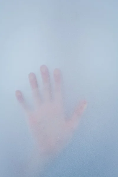 Hand touching frosted glass — Stock Photo, Image