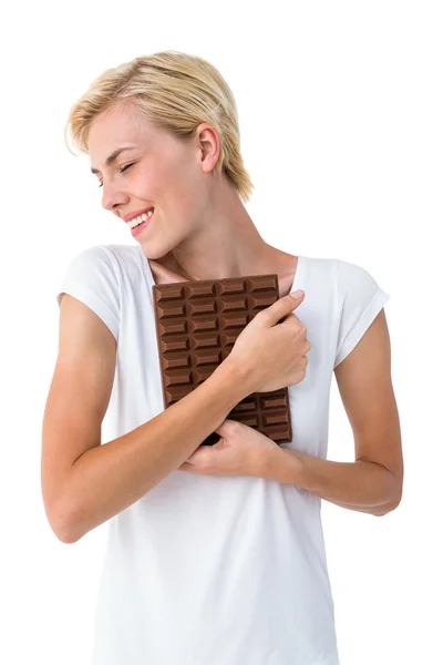 Woman hugging bar of chocolate — Stock Photo, Image