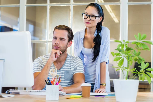 Smiling partners working together on computer — Stock Photo, Image