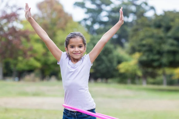 Happy girl playing with hula hoops — Stok fotoğraf