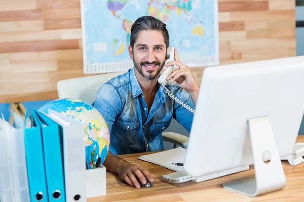 Smiling travel agent having phone call — Stock Fotó
