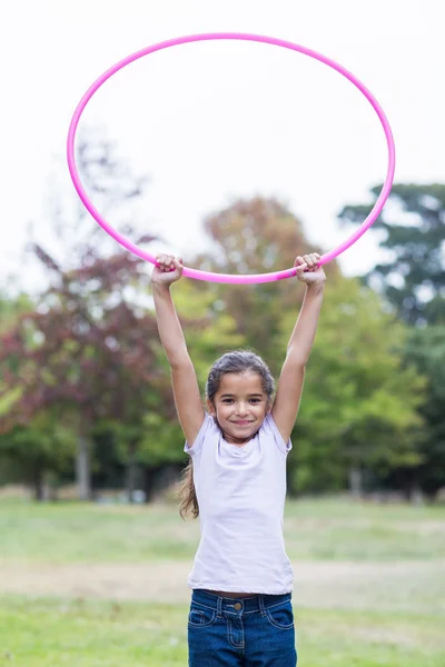 Happy girl playing with hula hoops — Stok fotoğraf