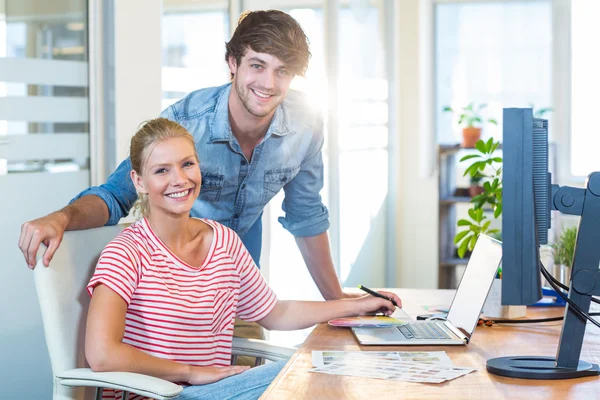 Smiling team working with digitizer and laptop — Zdjęcie stockowe