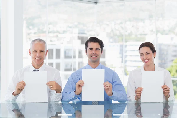 Smiling business team showing paper — Stock Photo, Image