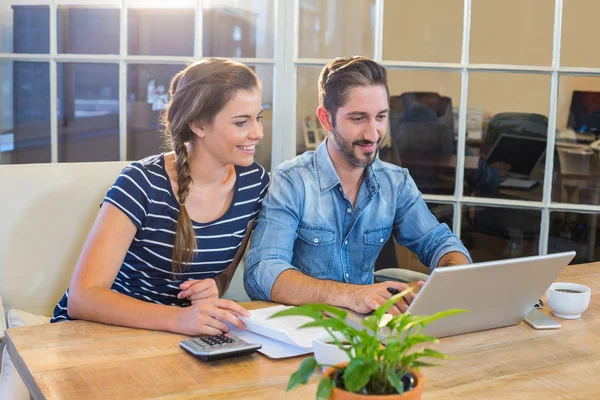 Partners working at desk using laptop — Stock Photo, Image