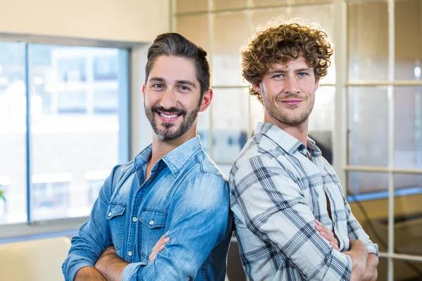 Smiling team standing arms crossed — Stock fotografie