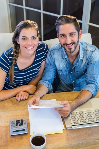Partners working at desk and smiling at camera — Stok fotoğraf