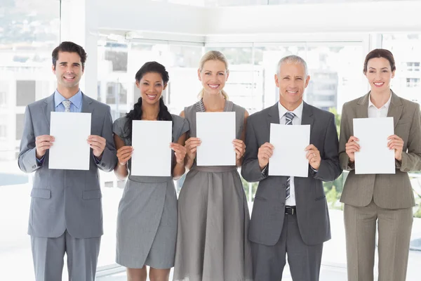 Business colleagues holding sheets of paper together — Stock Photo, Image