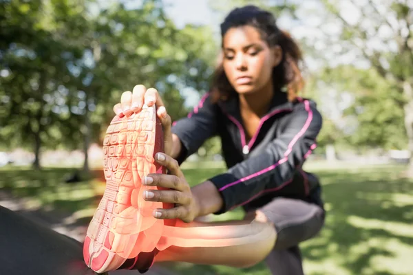 Highlighted ankle of stretching woman — Stock Photo, Image